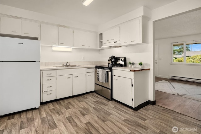 kitchen featuring a baseboard radiator, electric range, a sink, light countertops, and freestanding refrigerator