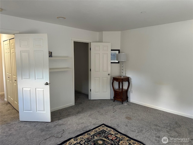 unfurnished bedroom featuring carpet floors and baseboards