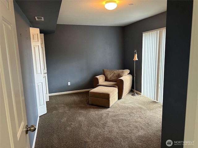 living area featuring carpet floors, visible vents, and baseboards