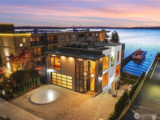 modern home featuring a water view