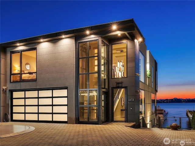 6413 Lake Washington Blvd NE, Kirkland, WA 98033 - view of outdoor structure with decorative driveway and a water view