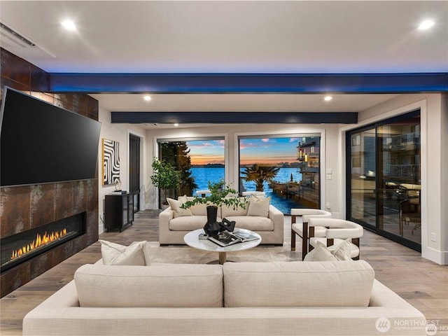 6413 Lake Washington Blvd NE, Kirkland, WA 98033 - living room featuring a fireplace, light wood-style floors, recessed lighting, a water view, and beamed ceiling