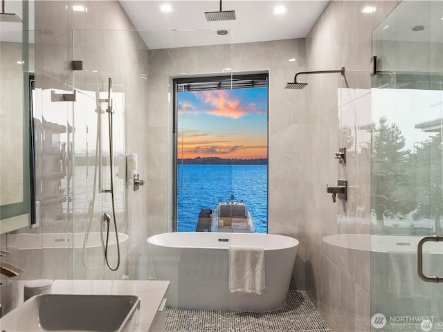 6413 Lake Washington Blvd NE, Kirkland, WA 98033 - full bath featuring a stall shower, a freestanding tub, tile walls, a water view, and vanity