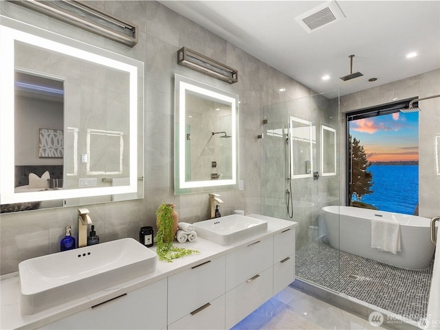6413 Lake Washington Blvd NE, Kirkland, WA 98033 - full bath with a shower stall, marble finish flooring, tile walls, double vanity, and a freestanding tub