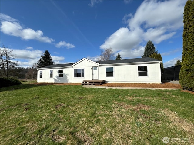 rear view of house with a yard