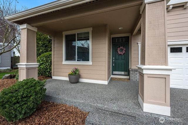 property entrance with a porch and a garage