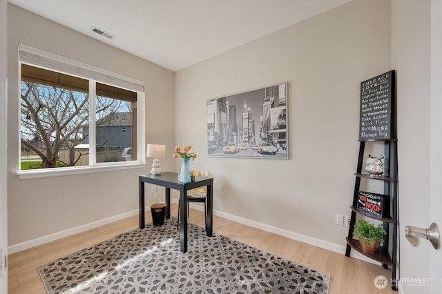 home office featuring visible vents, baseboards, and wood finished floors