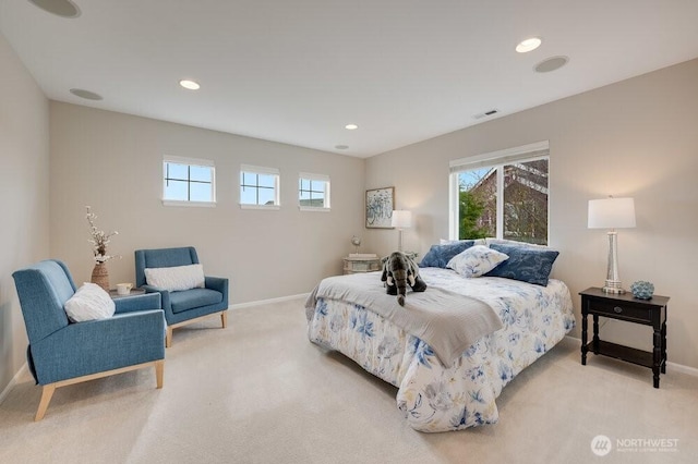 bedroom featuring visible vents, multiple windows, and light colored carpet