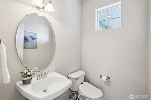 half bath with toilet and a sink