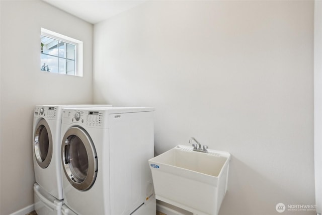 washroom with separate washer and dryer and baseboards