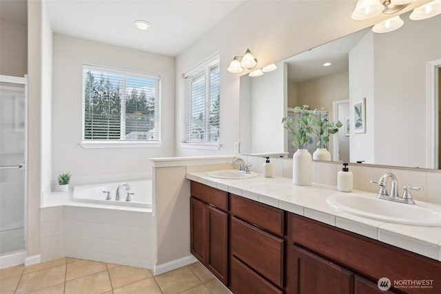 full bathroom featuring a bath, a shower with door, double vanity, and tile patterned floors