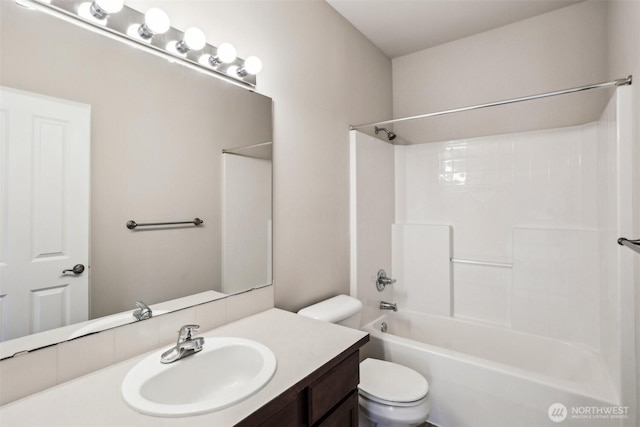 full bath with toilet, vanity, and shower / tub combination