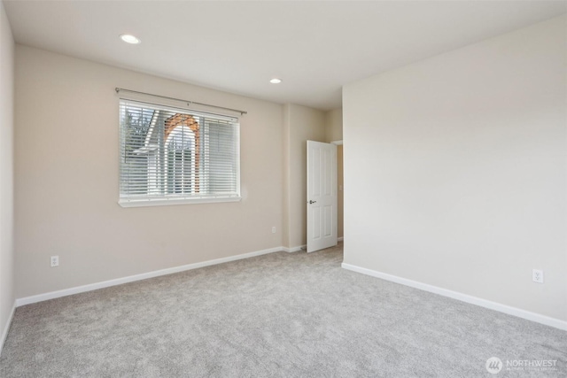 spare room featuring carpet flooring, baseboards, and recessed lighting