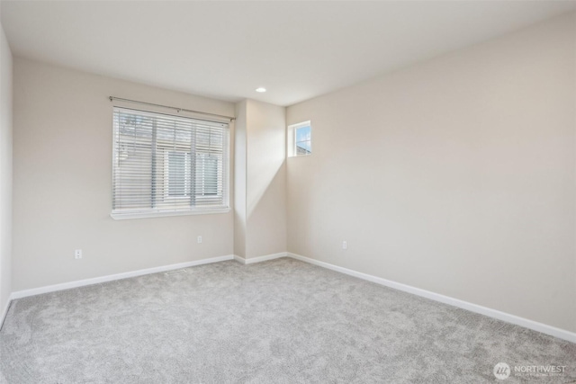 spare room with carpet flooring, baseboards, and recessed lighting