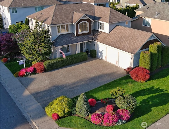 view of front of property with a garage, a shingled roof, driveway, and a residential view