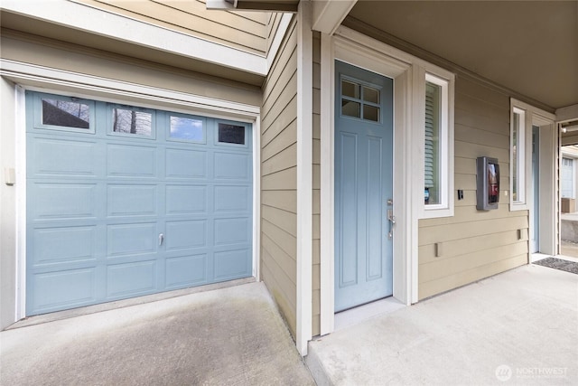 view of exterior entry featuring a garage