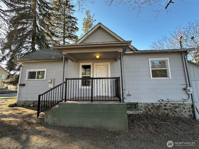 rear view of house with covered porch