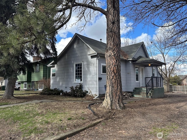 exterior space with roof with shingles