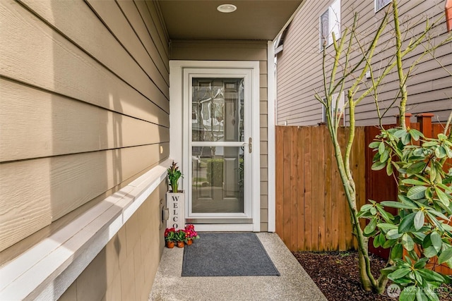 view of exterior entry with fence