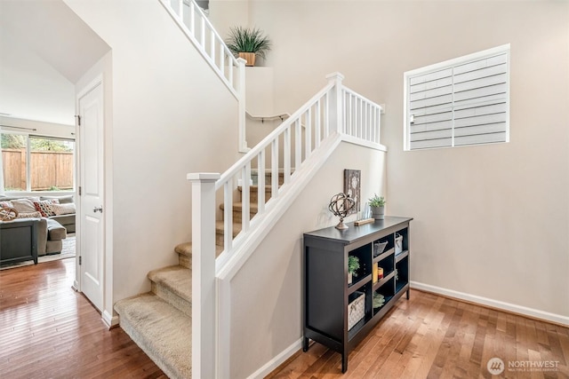 stairway with baseboards and wood-type flooring