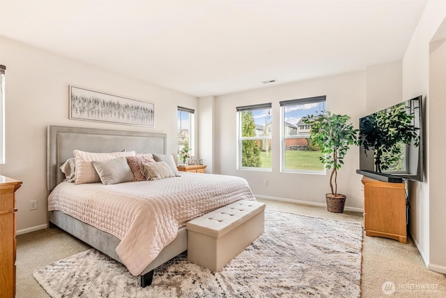 carpeted bedroom with visible vents and baseboards