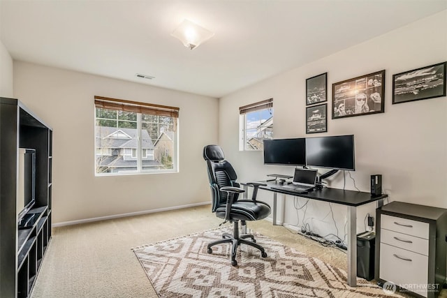 office space with visible vents, carpet flooring, and baseboards