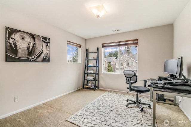 office with visible vents, light colored carpet, and baseboards