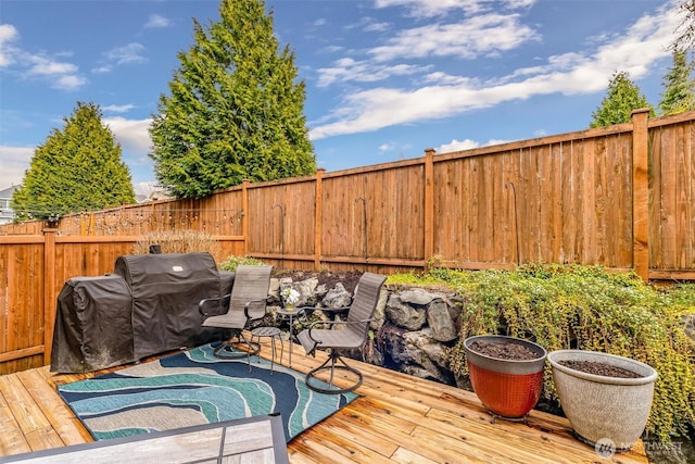 wooden terrace featuring fence and grilling area