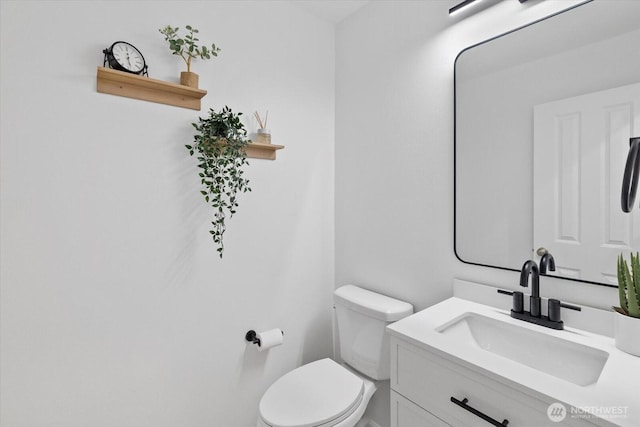 bathroom with toilet and vanity