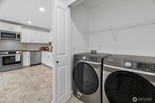 laundry room featuring washing machine and clothes dryer, laundry area, and recessed lighting