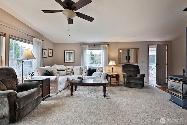 living room with carpet floors, ceiling fan, and vaulted ceiling