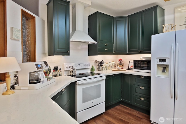 kitchen featuring green cabinets, white appliances, wall chimney range hood, and light countertops