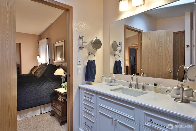 ensuite bathroom featuring connected bathroom and vanity