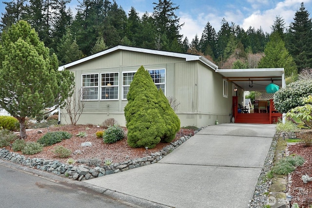 manufactured / mobile home featuring a carport, driveway, and crawl space