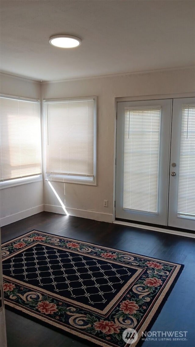 entrance foyer with dark wood finished floors and baseboards