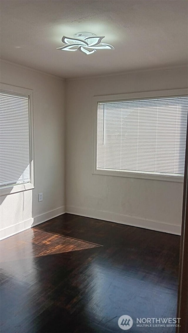 unfurnished room featuring baseboards