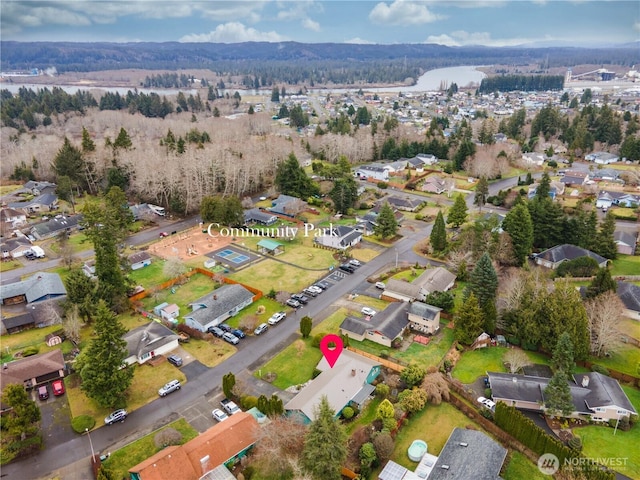 bird's eye view with a wooded view