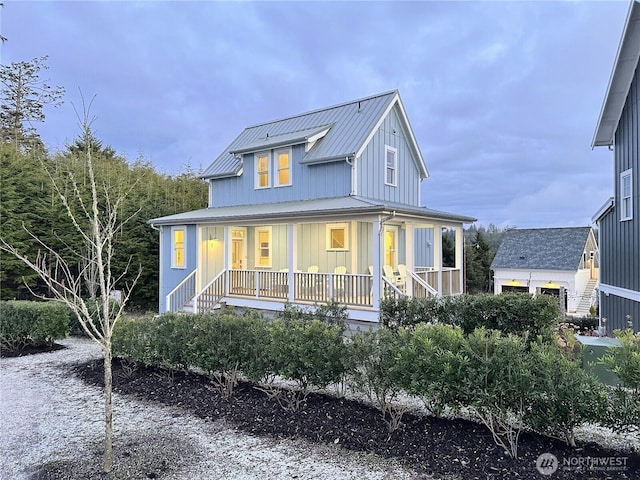 view of front of home with a standing seam roof, a porch, metal roof, and board and batten siding