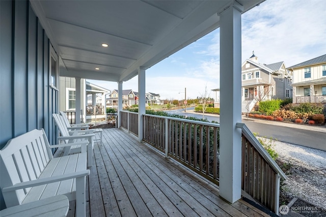 wooden deck with covered porch and a residential view