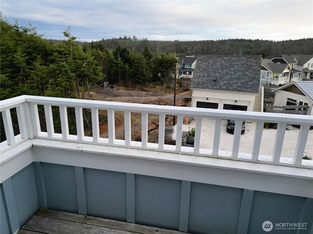 balcony featuring a view of trees