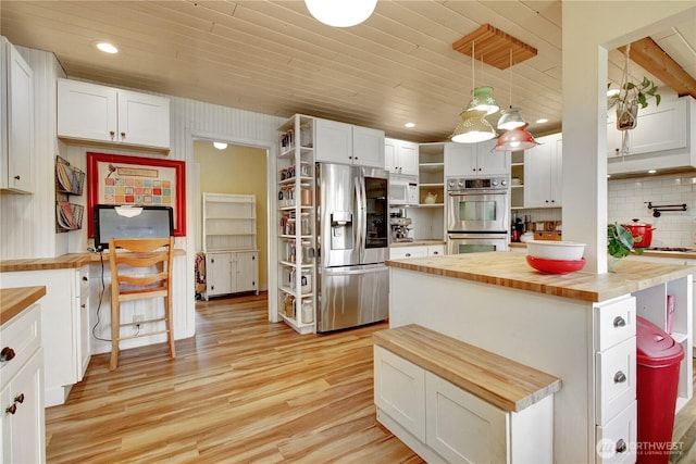 kitchen featuring butcher block counters, light wood-type flooring, white cabinets, stainless steel appliances, and open shelves