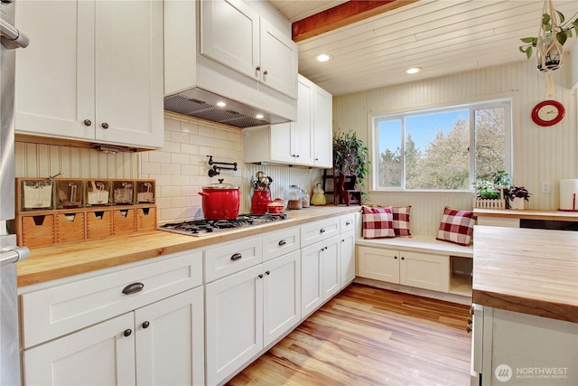 kitchen featuring white cabinetry, gas stovetop, light wood finished floors, and butcher block counters