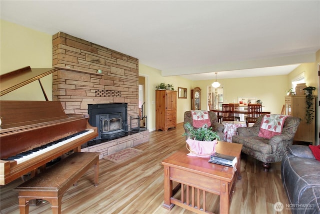 living room with light wood-type flooring and a wood stove