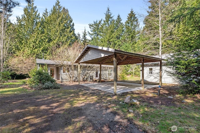 exterior space featuring a detached carport and driveway