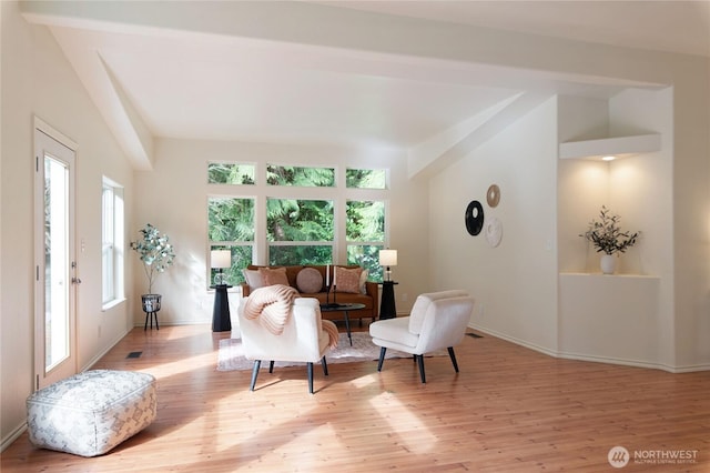 sitting room with visible vents, baseboards, and wood finished floors