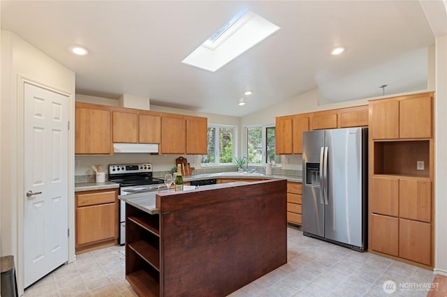 kitchen with a center island, under cabinet range hood, light countertops, stainless steel appliances, and a sink