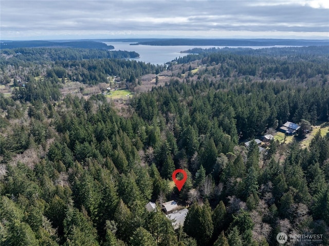 aerial view with a wooded view and a water view