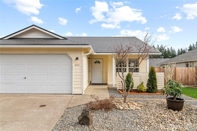 single story home featuring a garage, roof with shingles, driveway, and fence