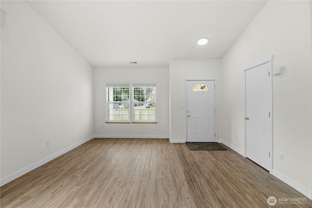 entryway with visible vents, wood finished floors, and baseboards