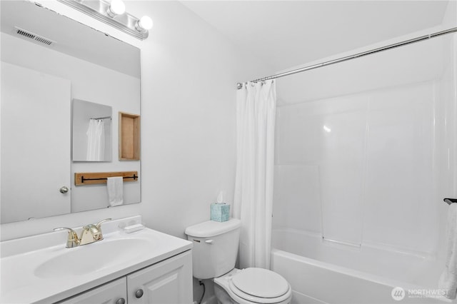 bathroom featuring visible vents, toilet, vanity, and shower / bath combo